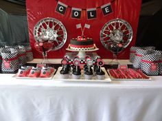 a table topped with lots of red and black items