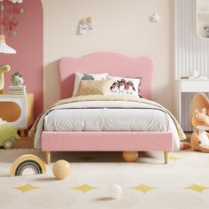 a child's bedroom decorated in pink and white with toys on the floor, including a bed