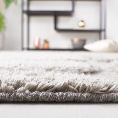 a white rug on top of a wooden floor