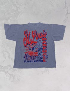 a blue t - shirt with the words st louis on it