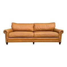 a tan leather couch with two pillows on it's back and arms, against a white background