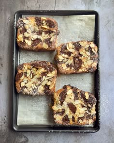 four pieces of bread with nuts on top