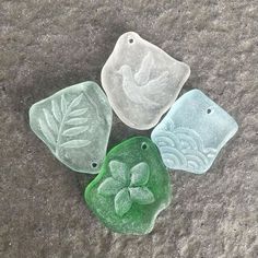 three pieces of glass sitting on the ground