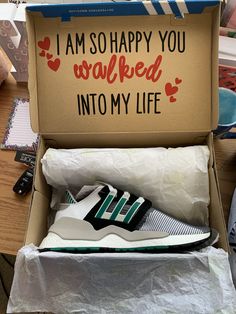 an open shoe box on a table with shoes in it that say i am so happy you walked into my life