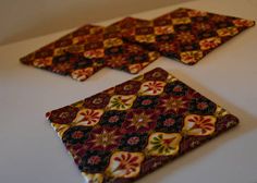 three square shaped coasters sitting on top of a white table next to each other