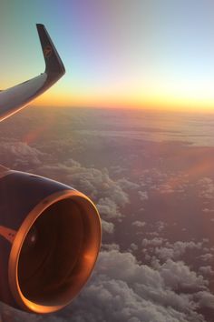 the wing of an airplane flying over clouds