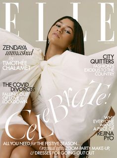 a woman is sitting on the cover of a magazine with her arms wrapped around her body