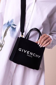 Givenchy mini g-tote shopping bag in black. 48% cotton, 48% linen, 4% polyurethane. Secondary material: 100% calfskin leather. Lining: 100% cotton. Metal pieces: 100% zamac 7.48 in x 6.3 in x 3.15 in Removable Strap, Min: 18.9 in L Fits Iphone 15 Pro Max Made in ITc Givenchy Bag, Givenchy Paris, Western Chic, Chunky Jewelry, Work Jewelry, Scarf Headband, Tie And Pocket Square, Clutch Wallet, Iphone 15 Pro