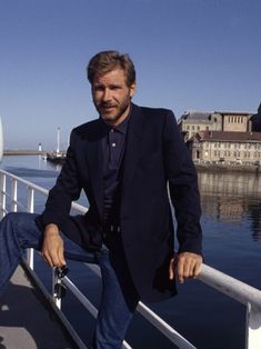 a man leaning on the railing of a boat