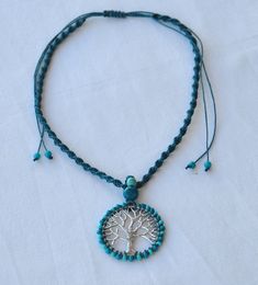 "Beautiful and Original Tree of Life necklace. If you just want to purchase the pendant choose option 1. If you want to purchase the pendant + macrame necklace choose option 2. The tibetan silver tree of life pendant is wrapped around with czech seed beads. The pendant hangs down from a turquoise macrame necklace. You can adjust the the length of the necklace + pendant from approx. 8,5\" (21 cm) to 15,5\" (39,5 cm) using the slider macrame clasp. Like this you have the choice to wear it closer t Hippie Turquoise Jewelry Gift, Handmade Hippie Turquoise Necklace, Turquoise Macrame Necklace For Festival, Handmade Turquoise Hippie Jewelry, Blue Macrame Hippie Jewelry, Blue Hippie Macrame Jewelry, Hippie Blue Macrame Jewelry, Adjustable Jewelry With Tree Of Life Round Pendant, Adjustable Tree Of Life Pendant Jewelry