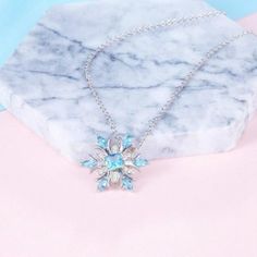 Discover the calming and empowering properties of Aquamarine with this stunning Snowflake Pendant Necklace. Aquamarine is known as a stone of life, breath, and memories, and has been used for centuries to promote inner peace, self-resolution, and expression. This beautiful blue-green stone is also believed to energize the throat chakra, empowering the wearer to speak their mind fearlessly. Whether you're dealing with conflicts, chronic procrastination, or simply seeking inner tranquility, this n