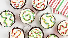 cupcakes with white frosting and colorful sprinkles