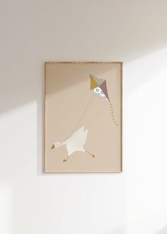 a painting hanging on the wall with a kite flying in the sky above it,