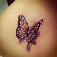 a woman's stomach with a butterfly tattoo on it