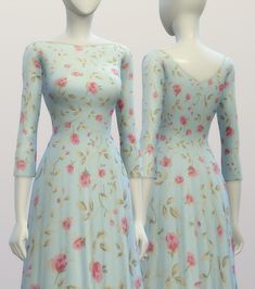 two mannequins dressed in blue dresses with pink flowers on them, facing each other