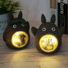 two little black animals with yellow lights on them