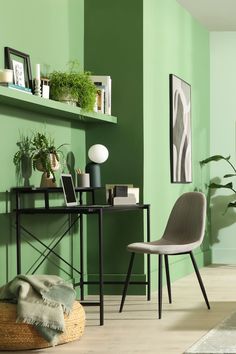 a living room with green walls and white flooring, two chairs in front of a black table