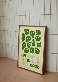 there is a poster on the wall with words written in green and white letters that read life is good, life is good