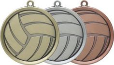 three different colored volleyball medals are shown in this image, one is gold, the other is silver