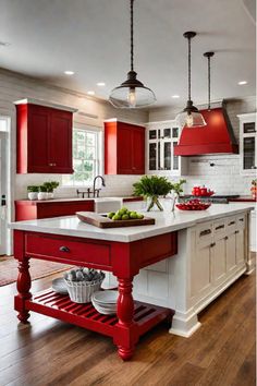 a kitchen with red and white cabinets, an island and two lights hanging from the ceiling