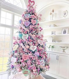 a pink christmas tree with lots of hearts