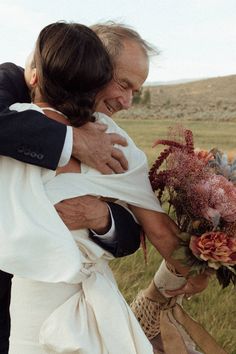 a man and woman hug each other outside