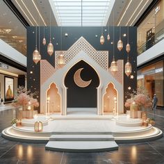 the entrance to an indoor shopping mall with lights and decorations on display in front of it