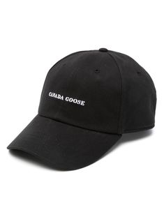 the canada goose hat is black with white embroidered on it, and reads canada goose