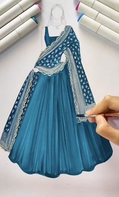 a drawing of a blue dress being drawn by someone using crayon pencils