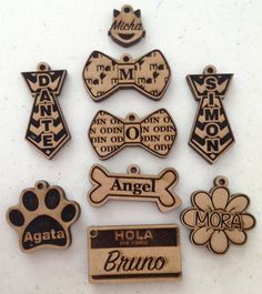 there are many different types of dog tags on the table, including one with a name tag