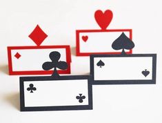 three cards with hearts and spades on them sitting next to each other in front of a white background