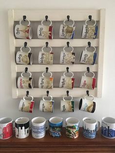 coffee cups are lined up on a shelf