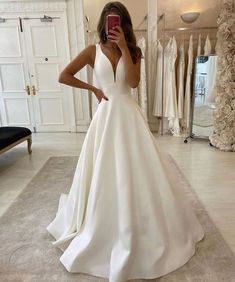 a woman taking a selfie in her wedding dress