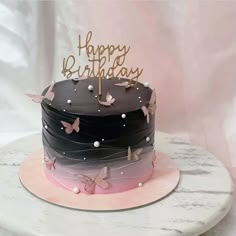 a birthday cake decorated with butterflies and the words happy birthday written on top in gold