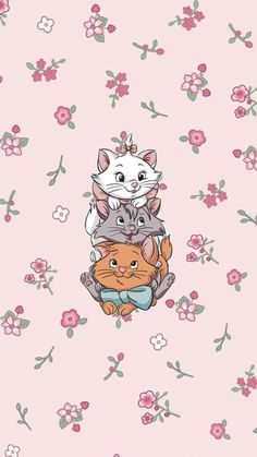 a group of cats sitting on top of each other in front of pink and green flowers