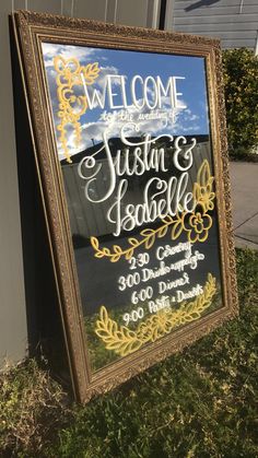 a sign for a wedding welcomes guests to the venue and is in front of a building