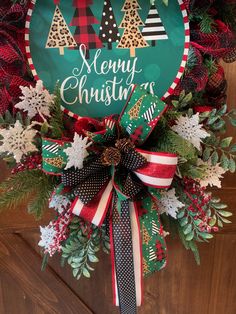 a christmas wreath with the words merry christmas on it