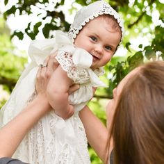 "Grace Bonnet | Ivory An absolutely beautiful bonnet for your little girl's christening day. This lace bonnet is uniquely designed with richly embroidered light ivory lace and cotton floral edge lace at the back. It is a fitted style for a traditional feel that will have friends thinking it was passed down in your family for generations. The keyhole in the back is adjustable for a near custom fit to your little one- just tie it tighter or relax the ribbon for a more loose fit. The silk ribbon ti Cute Fitted Baptism Dress, Fitted Cute Baptism Dress, Cute White Baptism Dress For Wedding, Godmother Dress, Lace Baby Bonnet, Lace Bonnet, White Lace Romper, Heirloom Dresses, Baptism Gown