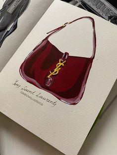 an open book with a drawing of a handbag on the cover and scissors next to it