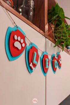 there is a sign that says love hanging from a line with paw prints on it