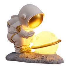 an astronaut figurine standing next to a glowing object