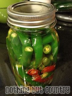 a jar filled with pickles sitting on top of a counter