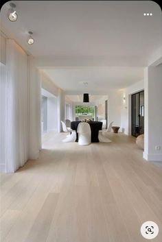 an empty living room with white walls and wood flooring is pictured in this image