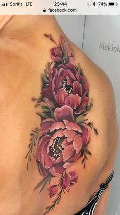 a woman's back with pink flowers on her left side and the bottom part of her stomach