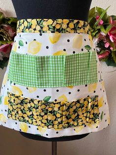 a woman's apron with lemons and gingham