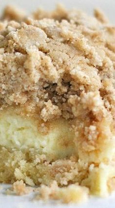 a close up of a piece of cake on a white plate with crumbs