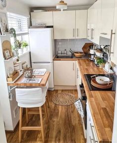 small kitchen with wooden counter tops and white cabinets