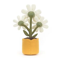 a small potted plant with white flowers in it's yellow cloth holder on a white background