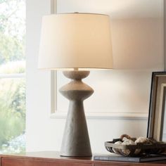 a table lamp sitting on top of a wooden dresser