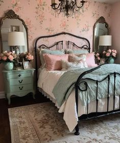 a bed room with a neatly made bed and a chandelier